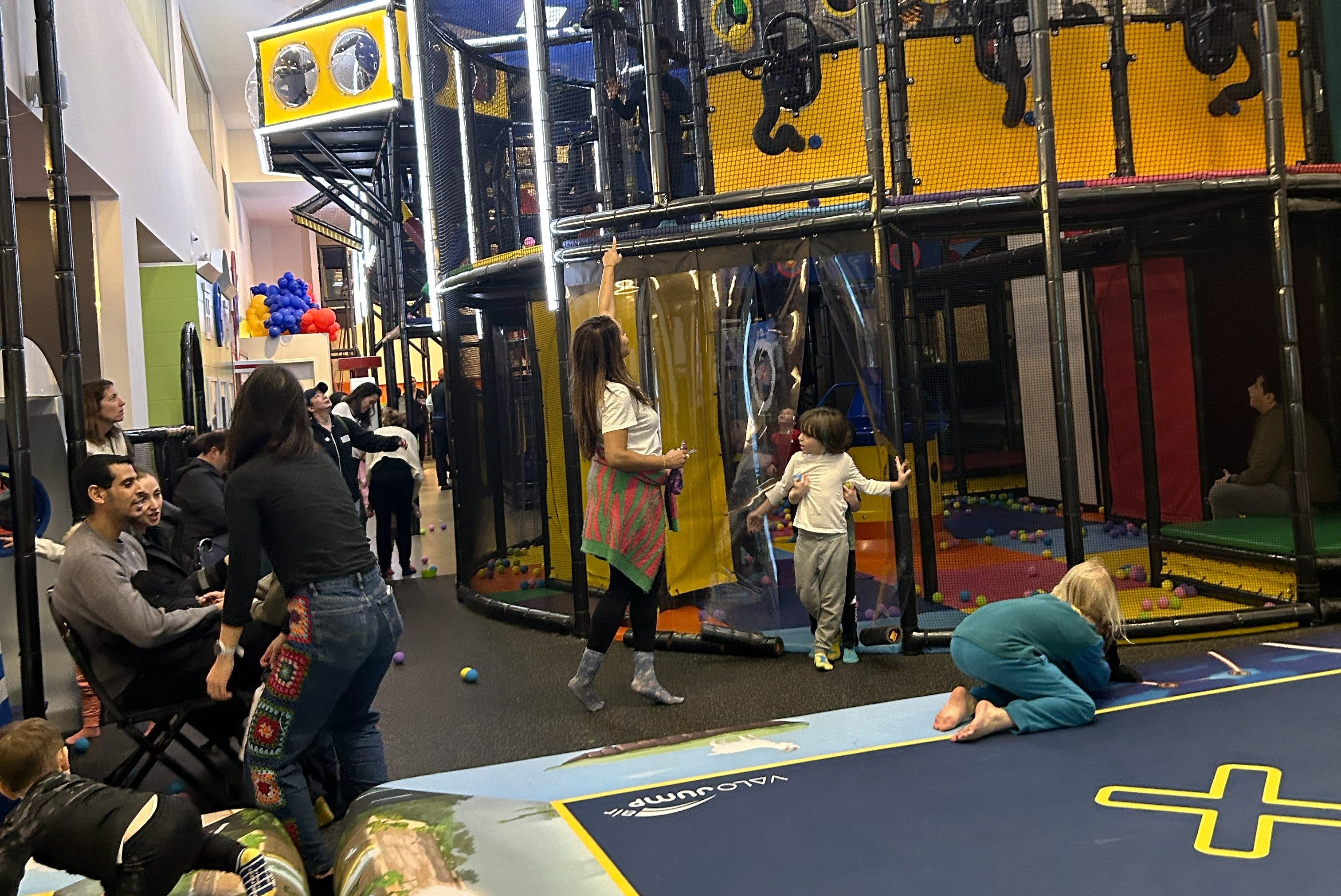 Indoor play spaces in Lower Manhattan: Indoor play space with large climbing structures and floor trampolines at Complete Playground